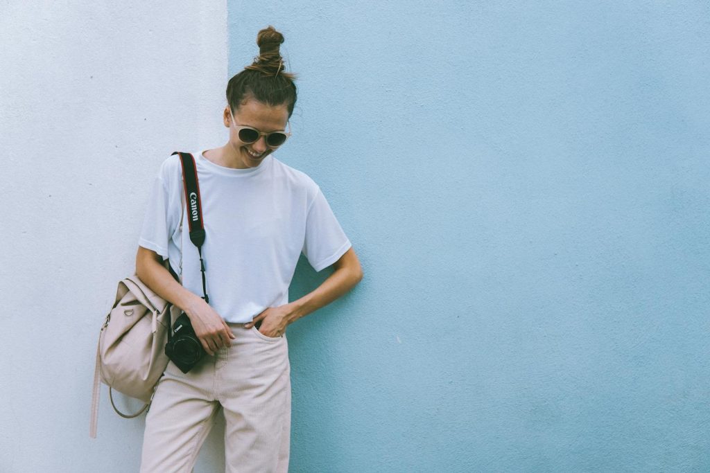 Woman Wearing White Crew-neck T-shirt With Black Canon Dslr On Her Shoulder